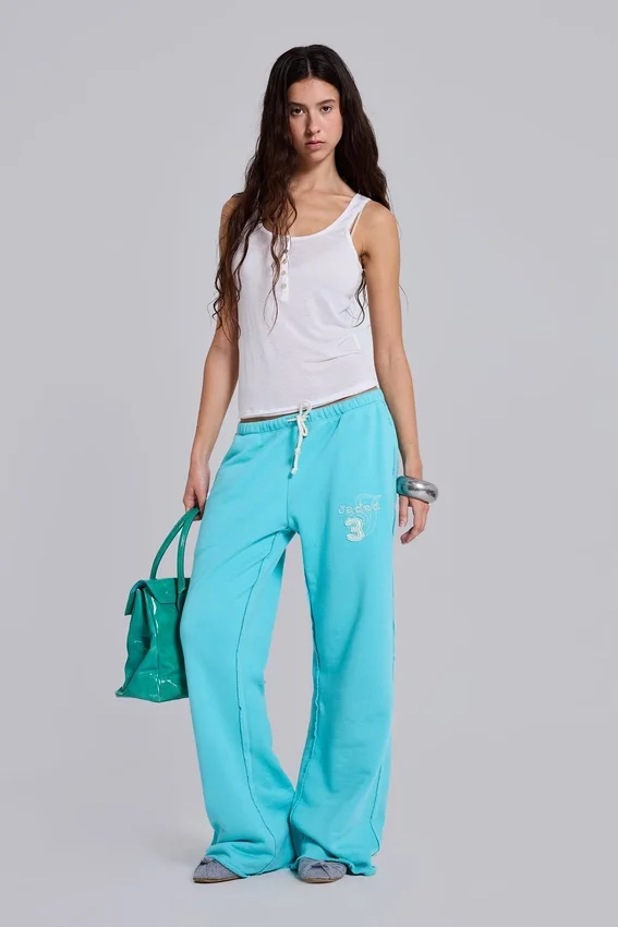 Pantalón de chándal holgado de corte acampanado Cleo en turquesa