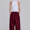 Pantalones de chándal «Vapor» metalizados en color burdeos
