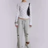 Pantalones jogger holgados de corte acampanado con efecto desgastado «Cleo»