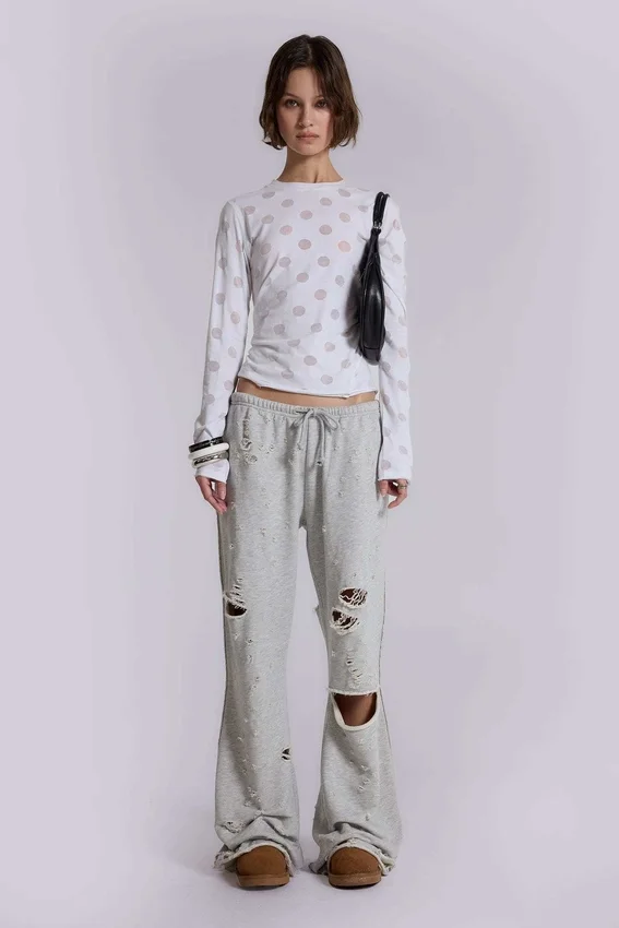 Pantalones jogger holgados de corte acampanado con efecto desgastado «Cleo»