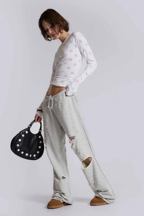 Pantalones jogger holgados de corte acampanado con efecto desgastado «Cleo»