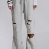 Pantalones jogger holgados de corte acampanado con efecto desgastado «Cleo»