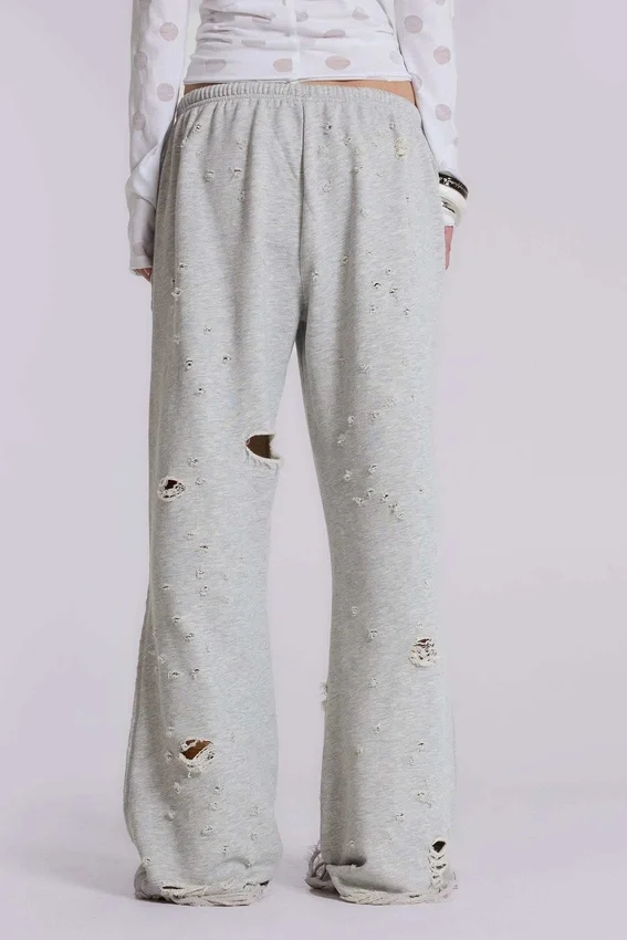 Pantalones jogger holgados de corte acampanado con efecto desgastado «Cleo»