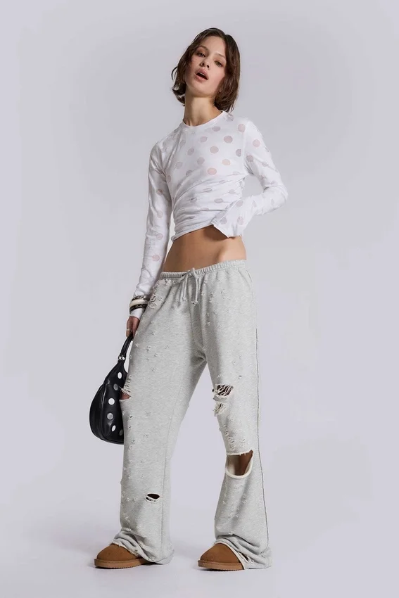 Pantalones jogger holgados de corte acampanado con efecto desgastado «Cleo»