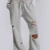 Pantalones jogger holgados de corte acampanado con efecto desgastado «Cleo»