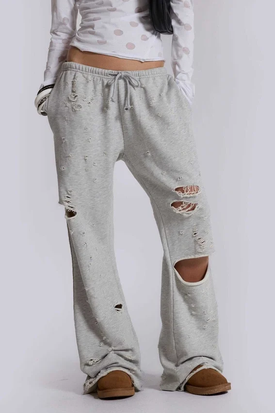 Pantalones jogger holgados de corte acampanado con efecto desgastado «Cleo»