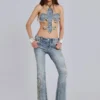 Top con flor de lis y tachuelas de Rock Revival