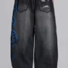 Vaqueros negros Colossus Jeans XL con rotos y diseño «Spike Airbrush»